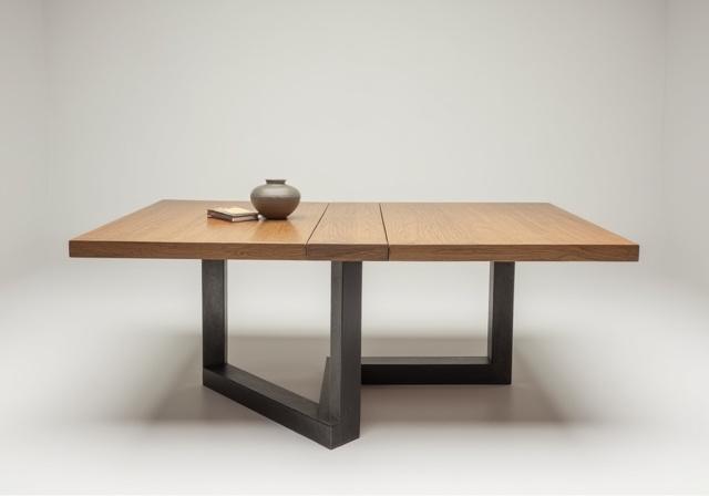 A minimalist dining table with a solid oak top and a sleek, hand-forged steel base.